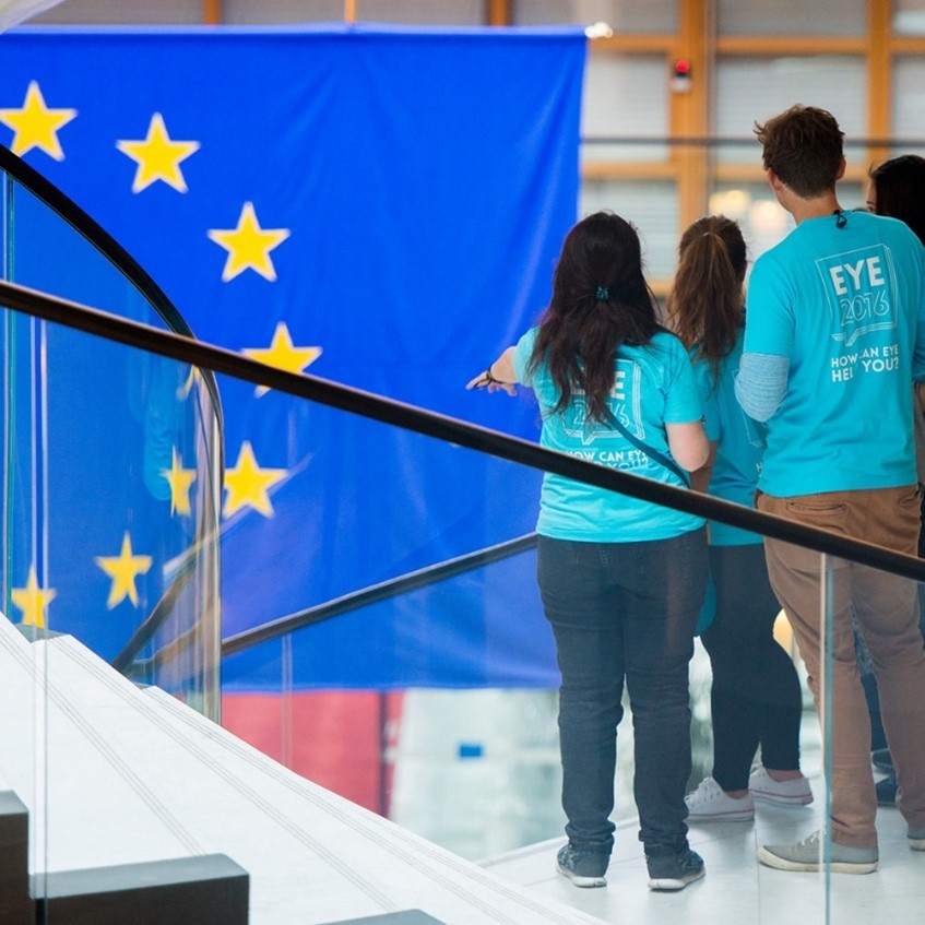 Teenage youth panellists in front of a European flag