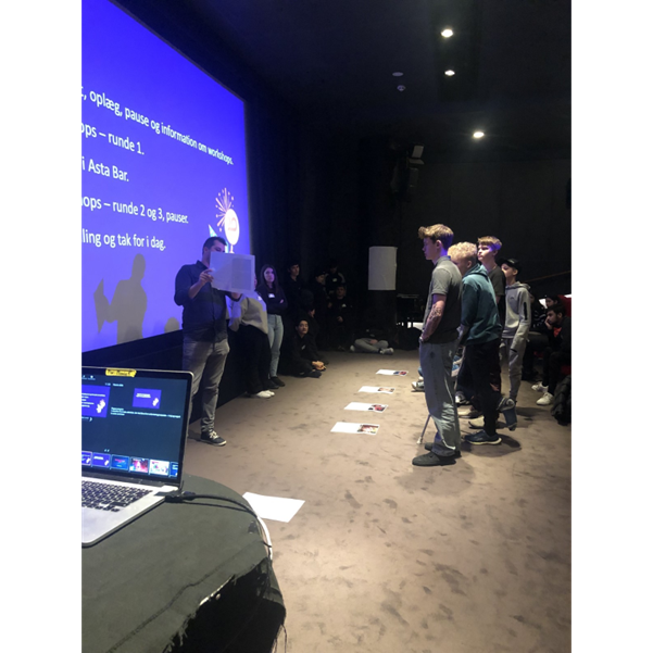 A group of three young people standing in front of a screen and performing an activity on SID2023 in Denmark.