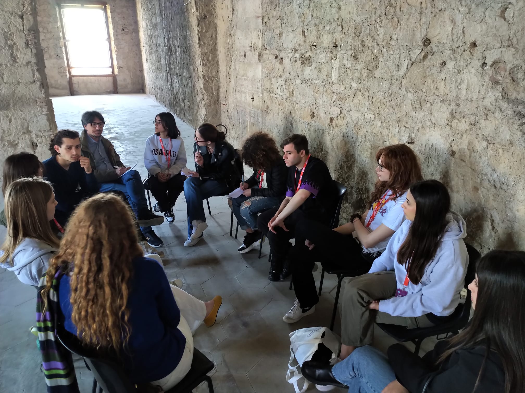 Young people discussing among themselves in a circle.