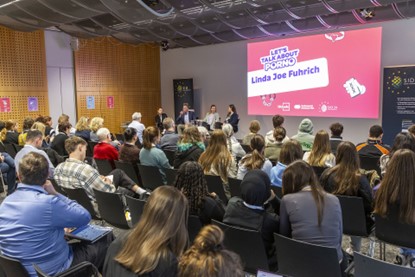 View of the conference venue of the main SID event in Mainz with lots of audience members watching a panel session.