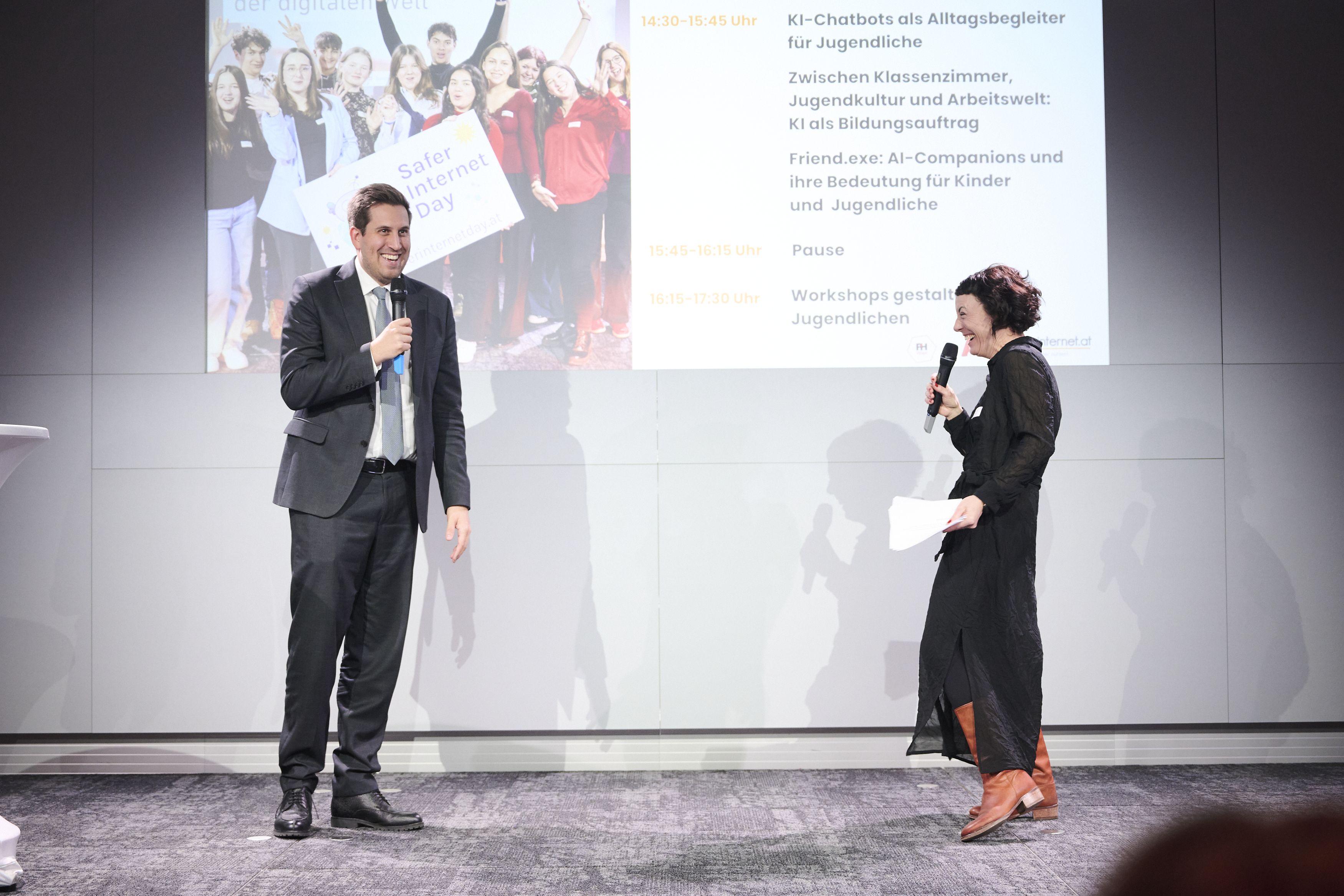 The minister conversating with the host on stage