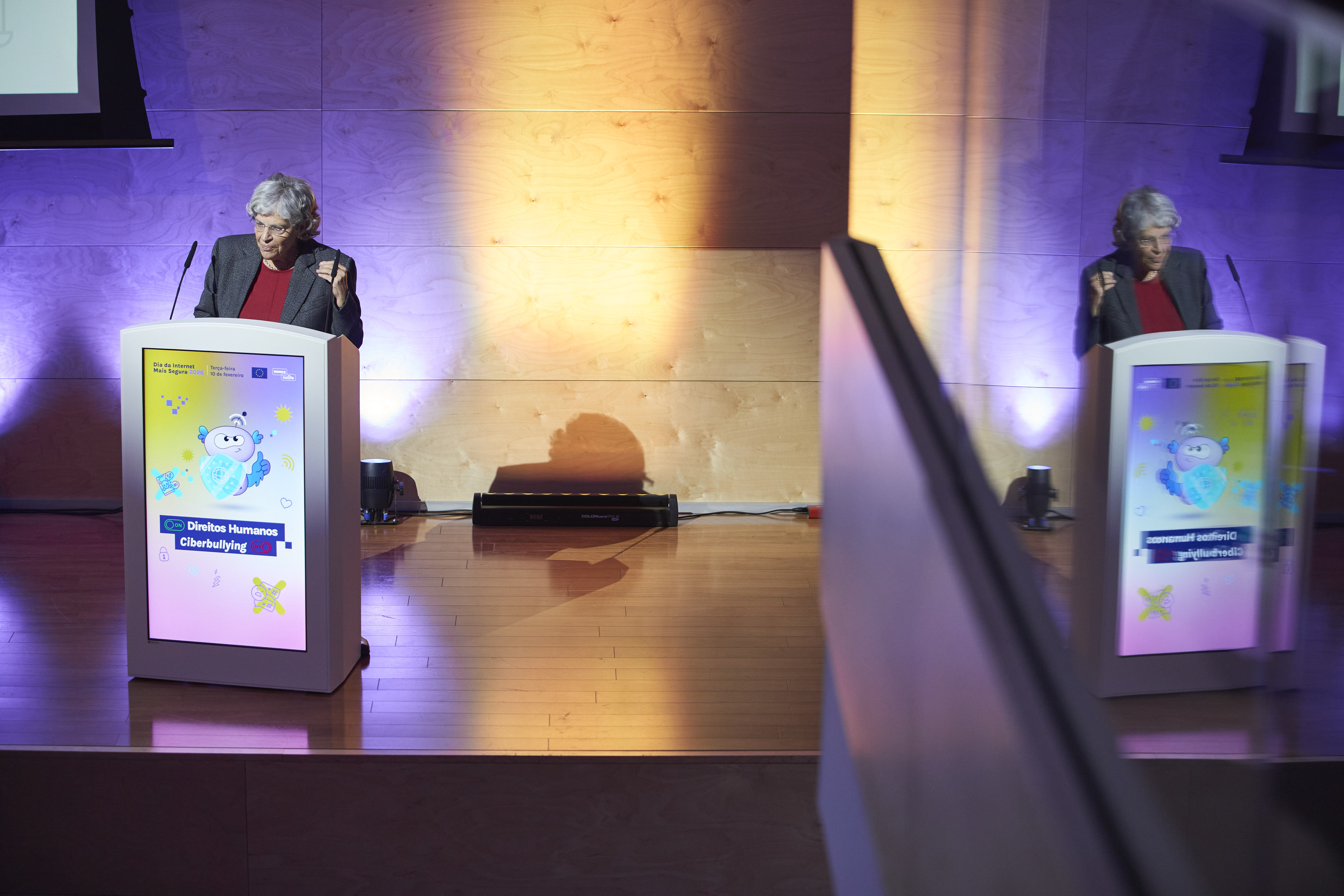 A panelist reflected on the wall at the venue of the SID high-level event in Portugal