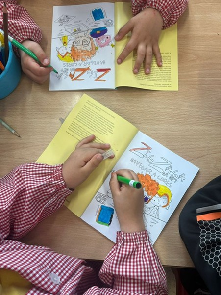 Children's hands colouring the book