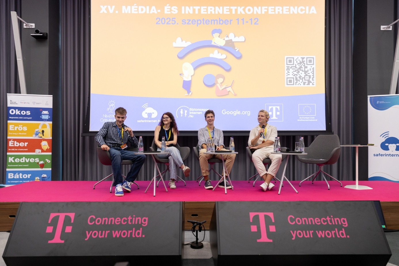 Overview of the stage at the cfonference, featuring four young people