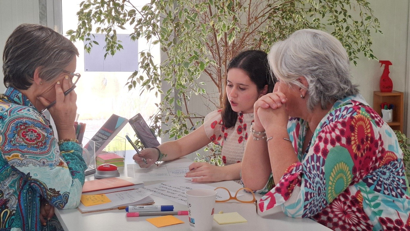 A young girl sharing her views with two adults during one of the sessions