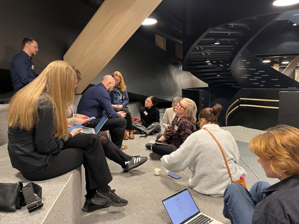 A group of experts sitting on steps and exchanging on online safety