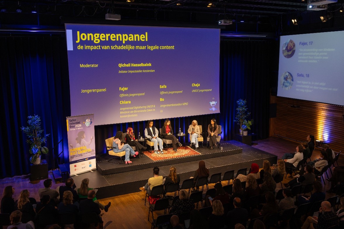View of the main stage at the conference, featuring six young people discussing harmful content