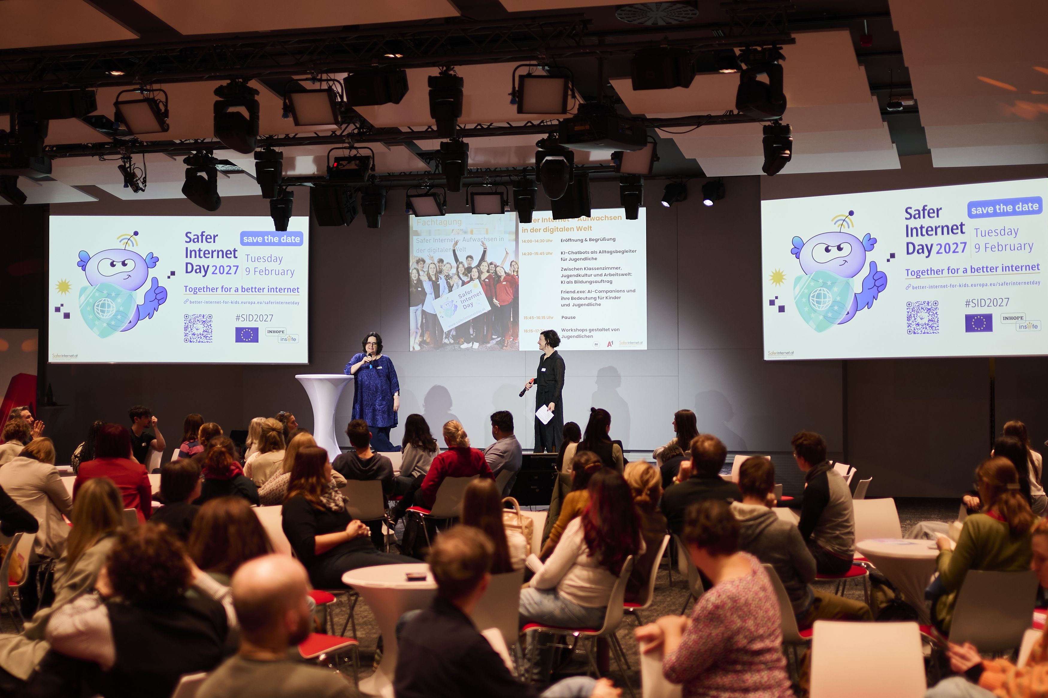Christine and Barbara speaking on stage