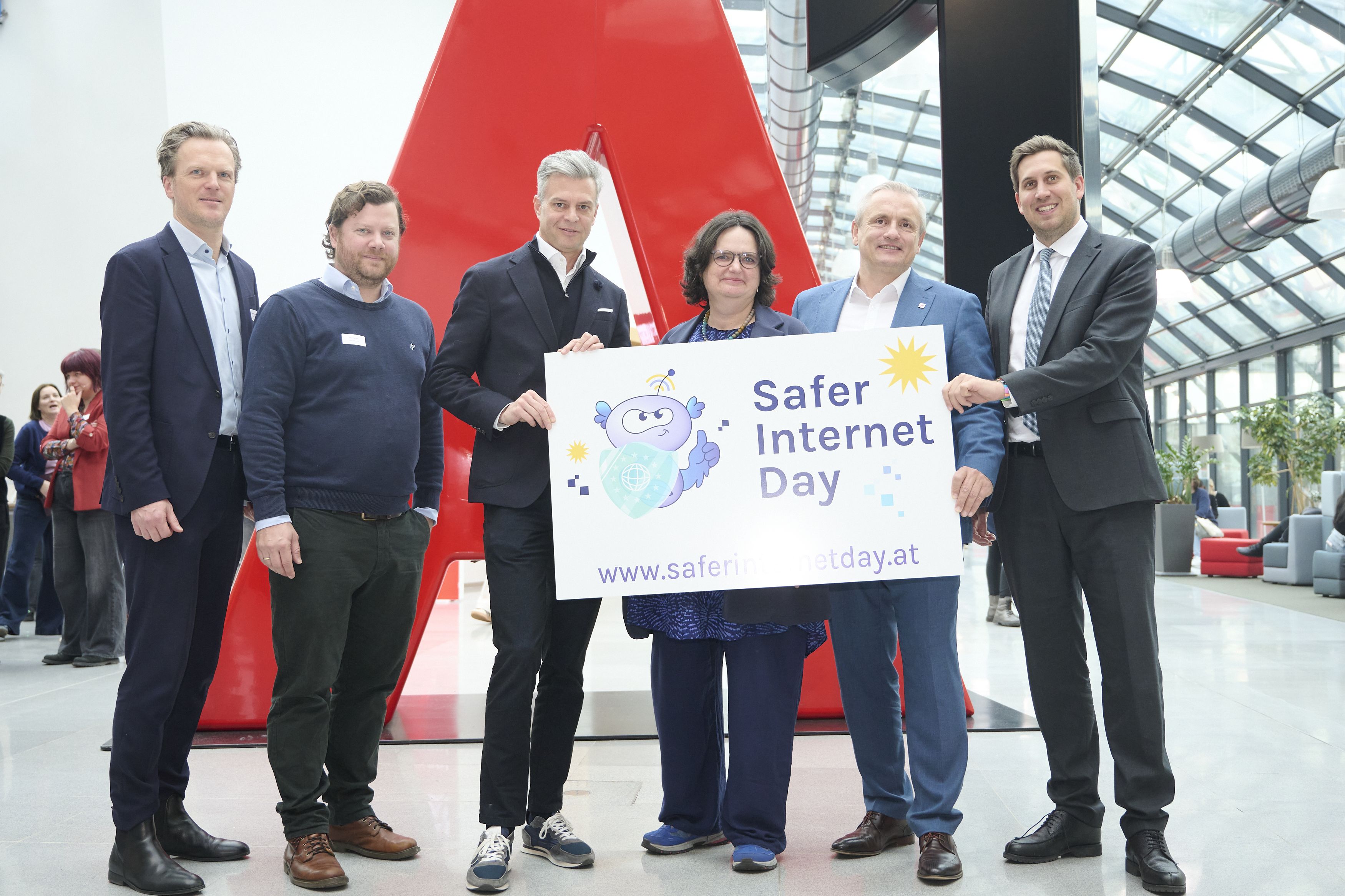 SIC Austria representatives and other high-level guests holding a SID banner