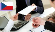 Two sets of hands are passing around important documents