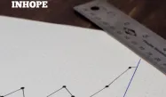 A graph on a piece of paper and two pens