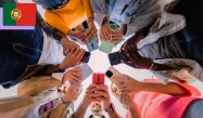 A group of young people standing in a circle, each holding a smartphone