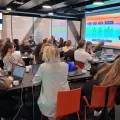 Group of experts from Nordic countries' SICs having a meeting in a large conference room