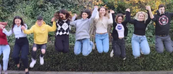 A group of 7 young people jumping
