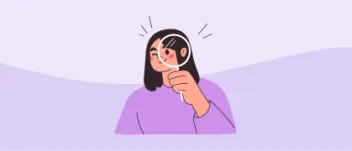 A young woman looking through a magnifying lens