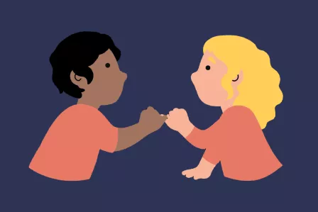 Two young people with their pinkies intertwined.
