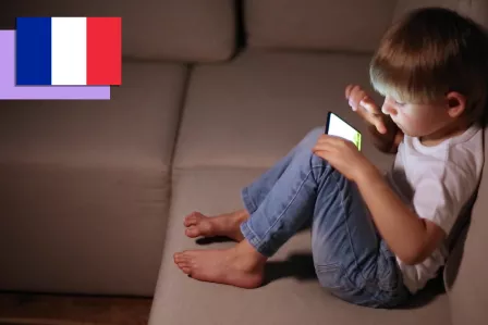 Little boy on a couch using a smartphone