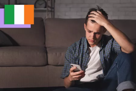Teenage boy using his phone looking distressed