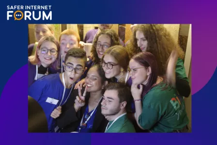 A group of young people smiling in front of the photo booth
