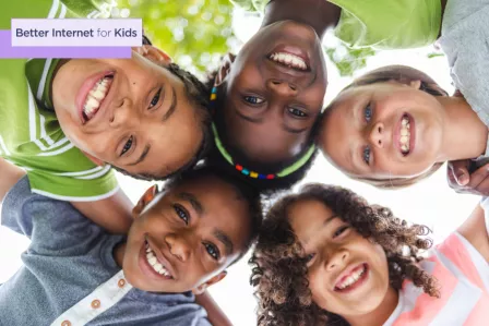 Children from different ethnicities hugging and smiling.