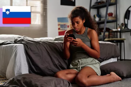 Girl on the floor looking through distressing content.