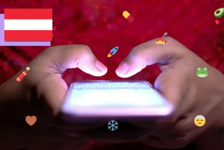 View of two hands tapping on a smartphone screen, and lots of social media icons surrounding the phone.
