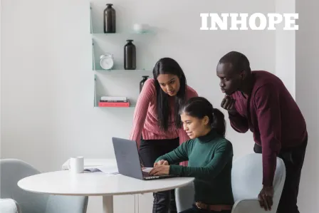 A group of three young people observing data on a laptop screen