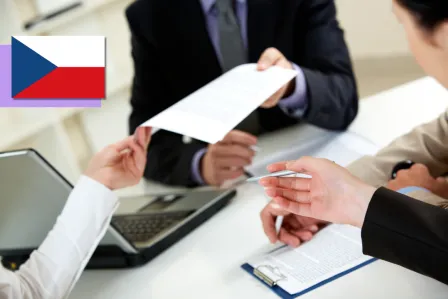 Two sets of hands are passing around important documents