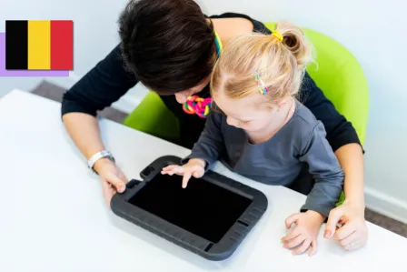 A mother and her toddler daughter playing on a tablet