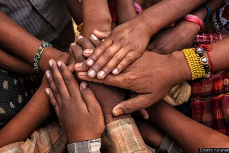 A group of hands intertwined together
