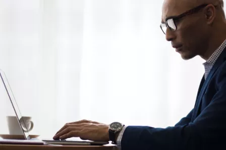 Man using a laptop in an office environment