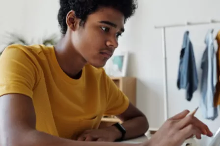Teenager interacting with a tablet screen