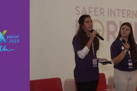 Two young girls speaking at a conference