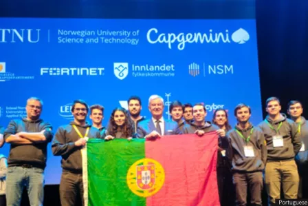 People standing on a podium holding a Portuguese flag