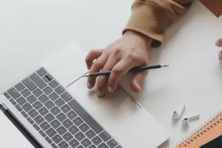 Birds-eye view of hands on a laptop keyboard
