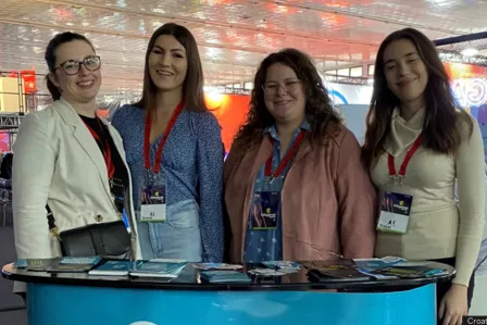 Croatian SIC team in front of a booth in a convention.