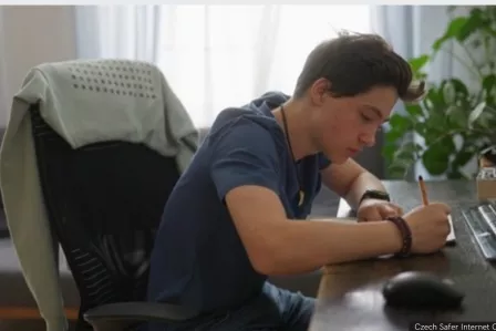 Young man writing on a blank paper.