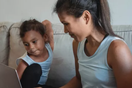 Parent and child using a laptop together
