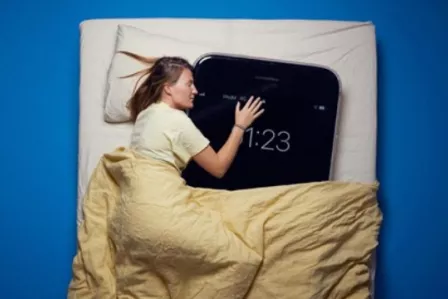 Woman sleeping with an over-sized smartphone