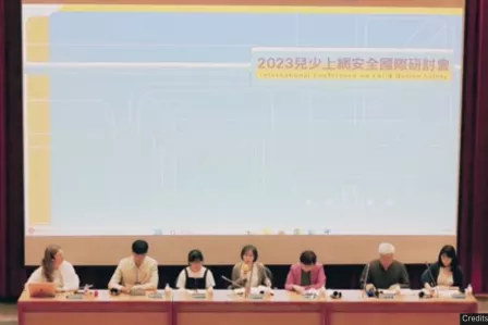 Picture of conference panel sitting at a table