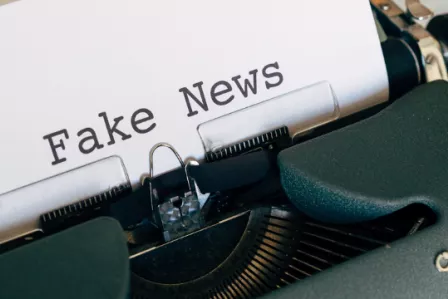 Old-fashioned typewriter displaying a page with Fake News in large font