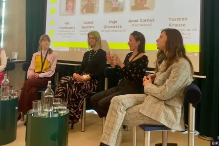 4 women discussing on stage