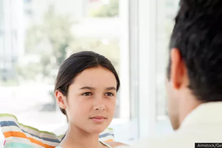 A girl looking pensive at the person talking to her