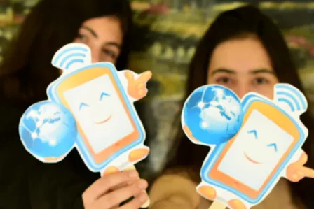 Greek students holding images of the SID mascot