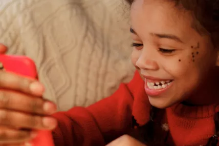 Young girl using a smartphone with her father