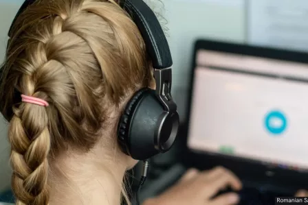 Girl with headphones watching a screen