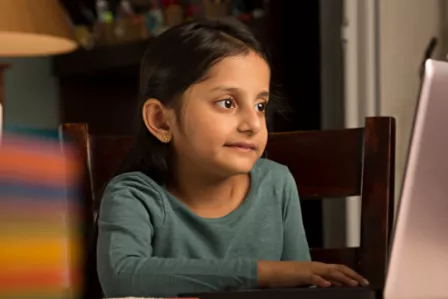 Child using a laptop in the home