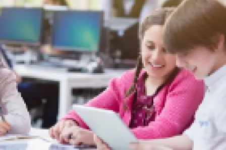 Children using devices in a classroom setting