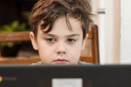 Young boy looking at his screen
