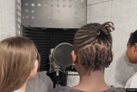 Young people recording a podcast in front of a microphone